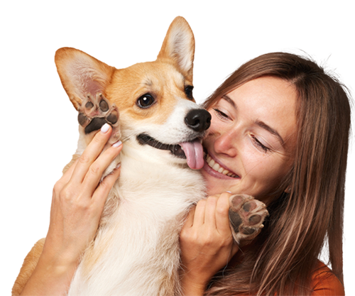 a woman holding a dog posing for the camera