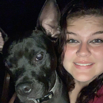 a close up of a person and a dog posing for the camera