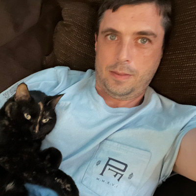 a man holding a cat