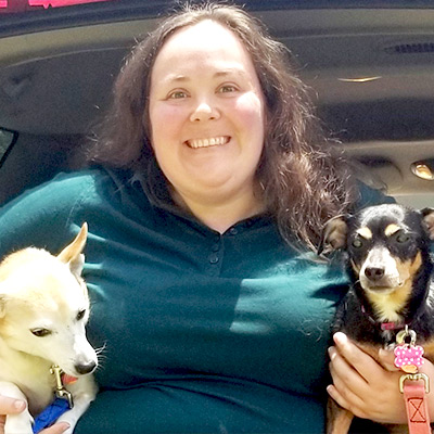 Lindsay Webb holding a dog in a car posing for the camera
