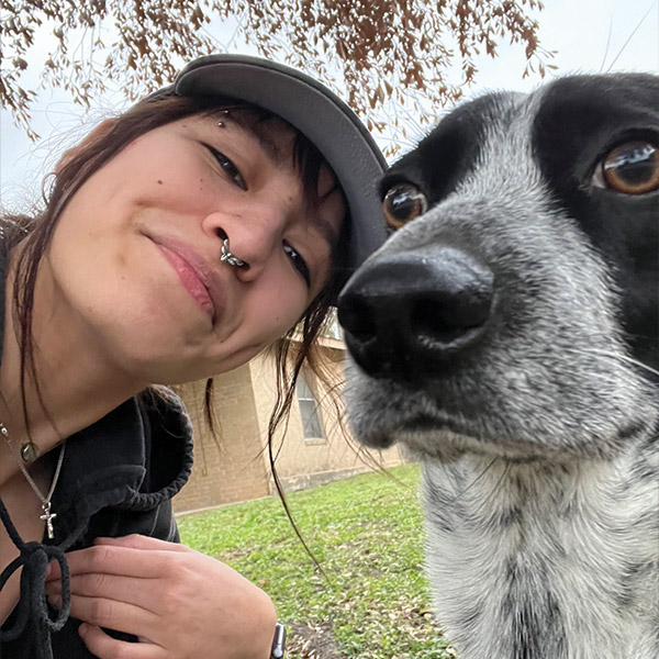 a close up of a woman and a dog posing for the camera