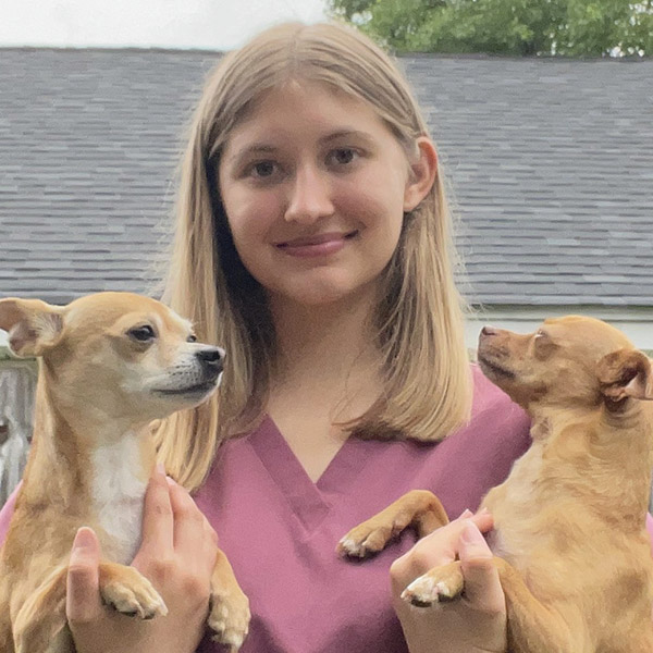 a woman and a dog posing for the camera